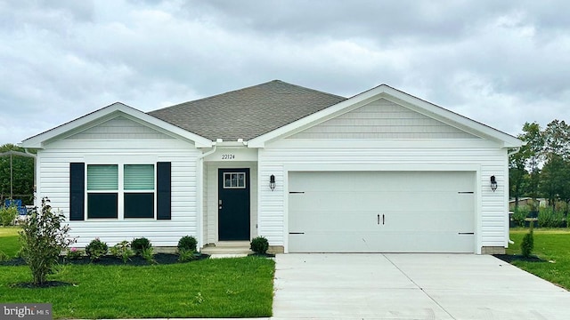 view of front of property with a garage and a front lawn