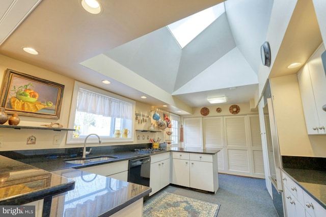 kitchen with a peninsula, a sink, white cabinets, and dishwasher