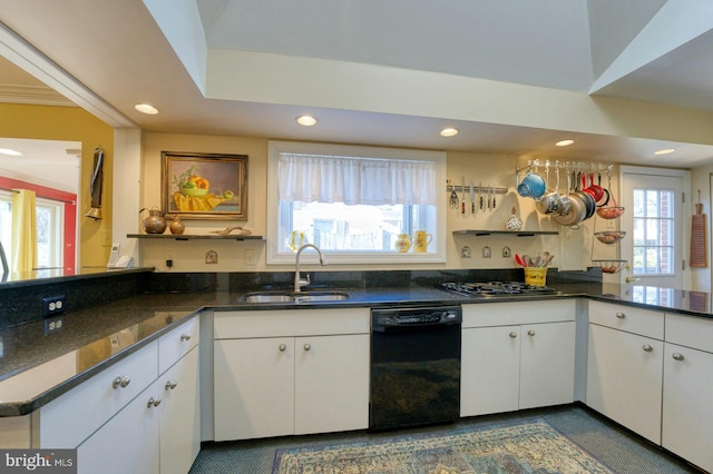 kitchen with black dishwasher, recessed lighting, white cabinetry, a sink, and a peninsula