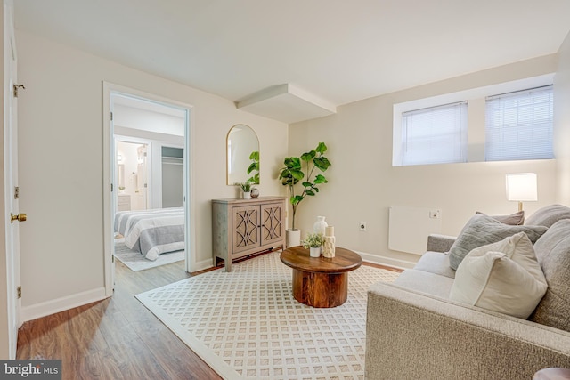 living area featuring baseboards and wood finished floors