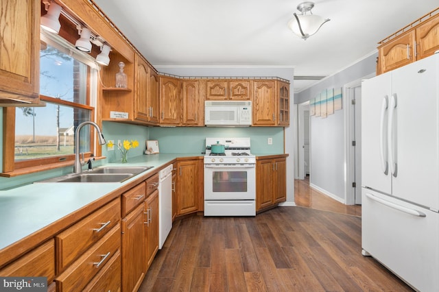 kitchen with white appliances, ornamental molding, dark hardwood / wood-style floors, and sink