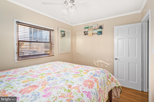 bedroom featuring hardwood / wood-style flooring, ceiling fan, and ornamental molding