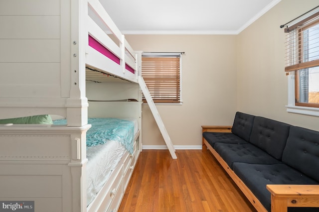 bedroom with hardwood / wood-style flooring and ornamental molding