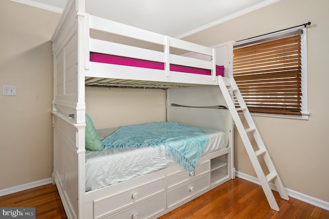 bedroom with hardwood / wood-style flooring and ornamental molding