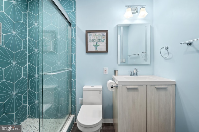 bathroom featuring walk in shower, vanity, and toilet