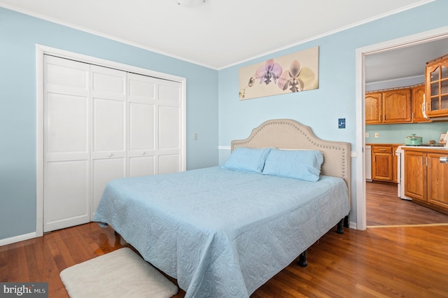 bedroom with crown molding, dark hardwood / wood-style floors, and a closet