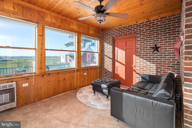 living room featuring carpet flooring, heating unit, brick wall, wooden ceiling, and wood walls