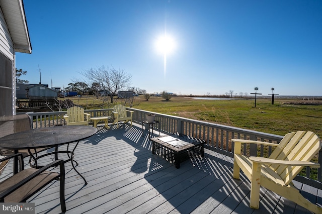 wooden terrace featuring a lawn