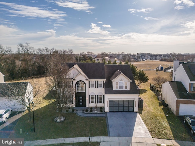 view of front facade with a garage and a front lawn