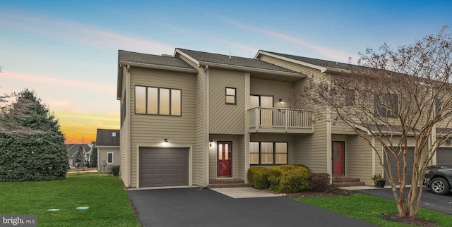 view of property with a yard and a garage