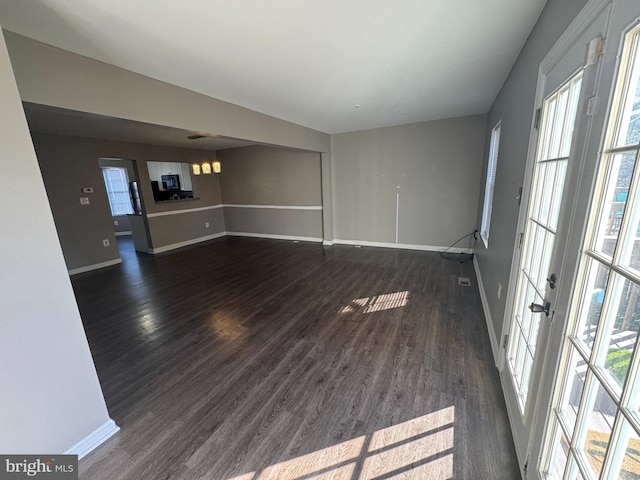 unfurnished living room featuring dark hardwood / wood-style floors