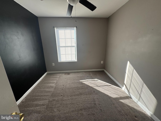 spare room with carpet floors and ceiling fan