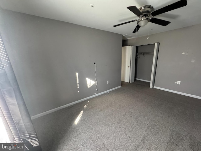 unfurnished bedroom featuring ceiling fan, dark carpet, and a closet