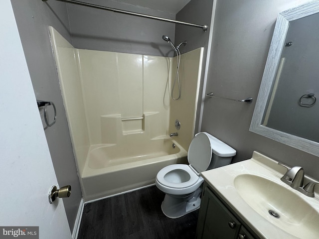 full bathroom featuring hardwood / wood-style flooring, toilet, vanity, and  shower combination