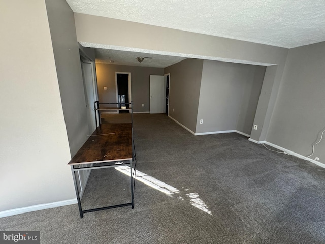 carpeted empty room with a textured ceiling