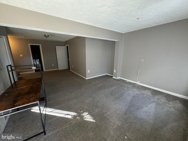 carpeted spare room with a textured ceiling