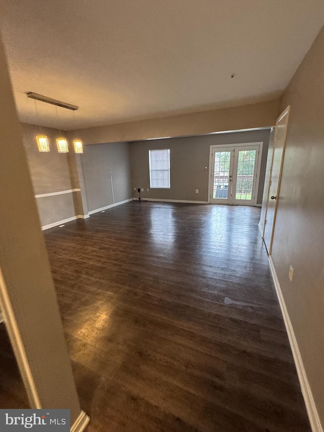 interior space with dark hardwood / wood-style flooring and french doors