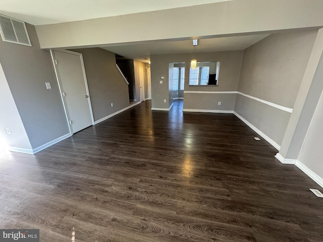 spare room featuring dark wood-type flooring