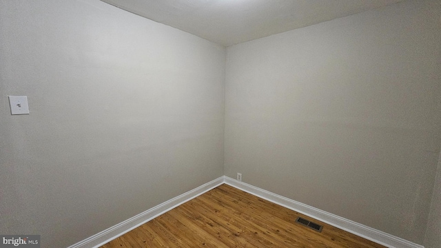 empty room with hardwood / wood-style flooring