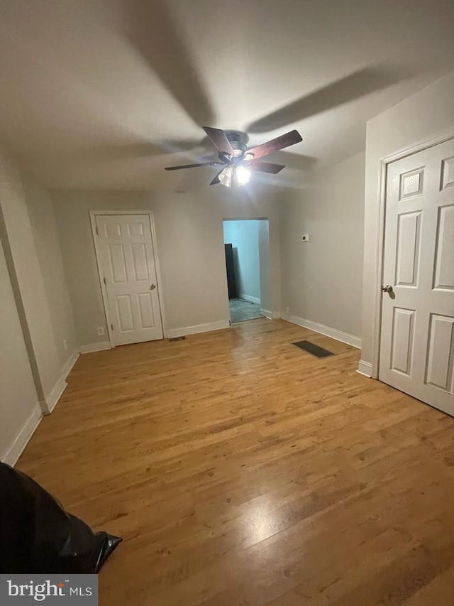 unfurnished bedroom featuring ceiling fan and light hardwood / wood-style floors