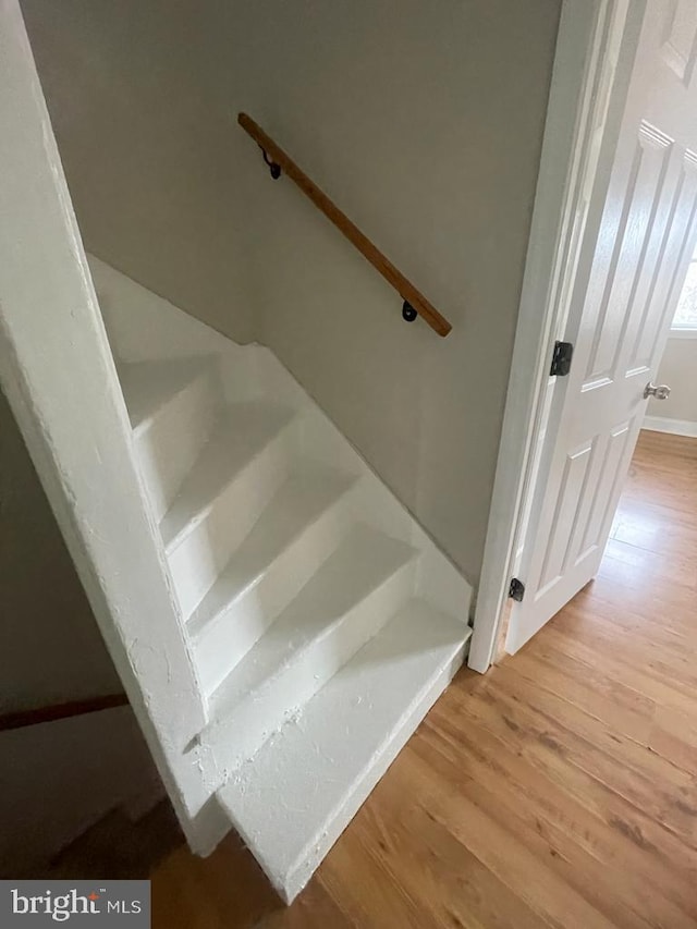 stairway featuring hardwood / wood-style flooring