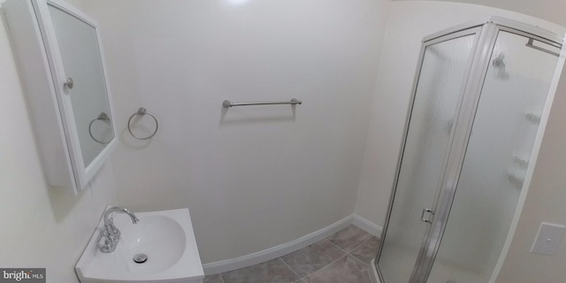 bathroom with tile patterned flooring, sink, and walk in shower