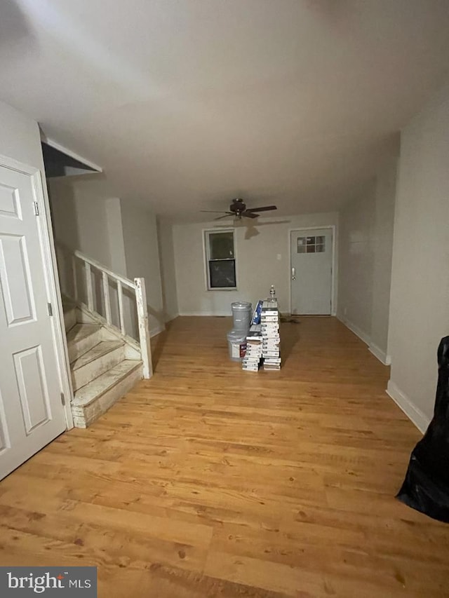 unfurnished living room with ceiling fan and light wood-type flooring