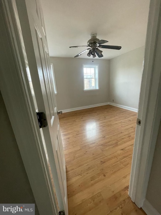 empty room featuring light hardwood / wood-style flooring and ceiling fan