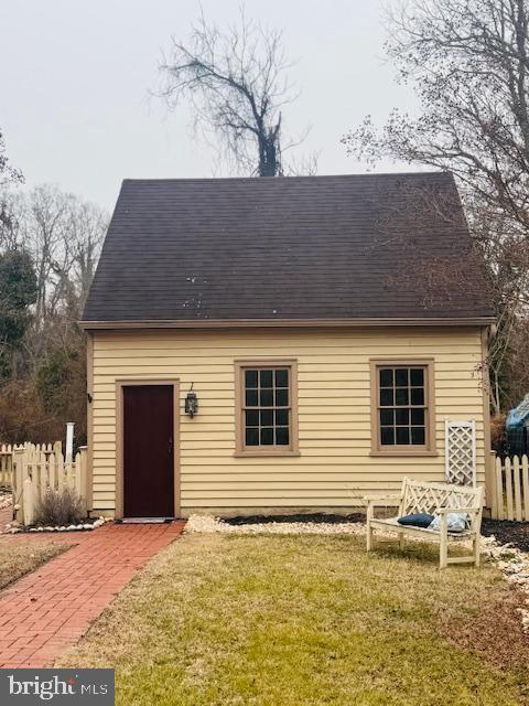 rear view of house with a yard