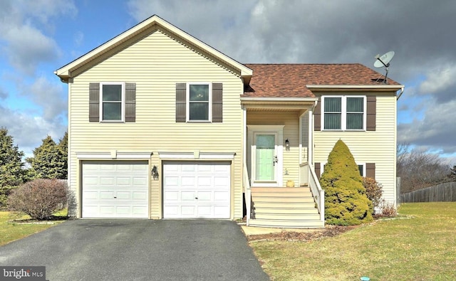 split foyer home featuring a garage and a front lawn