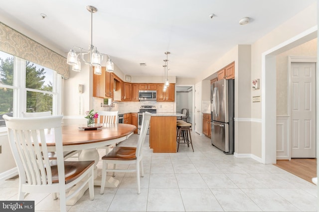 dining area featuring baseboards and light tile patterned floors