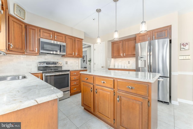 kitchen with light tile patterned flooring, appliances with stainless steel finishes, a sink, brown cabinetry, and backsplash