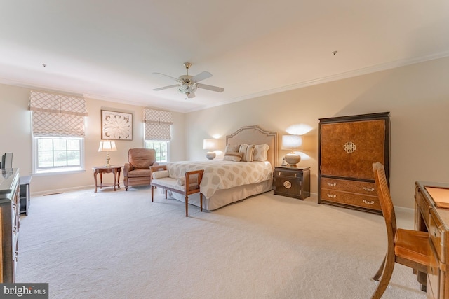 bedroom with baseboards, ornamental molding, ceiling fan, and light carpet
