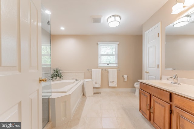 full bathroom featuring vanity, toilet, tile patterned floors, baseboards, and a garden tub