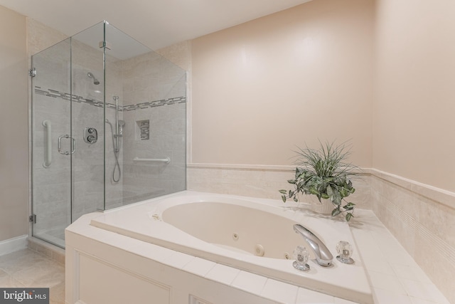 bathroom featuring a whirlpool tub and a shower stall