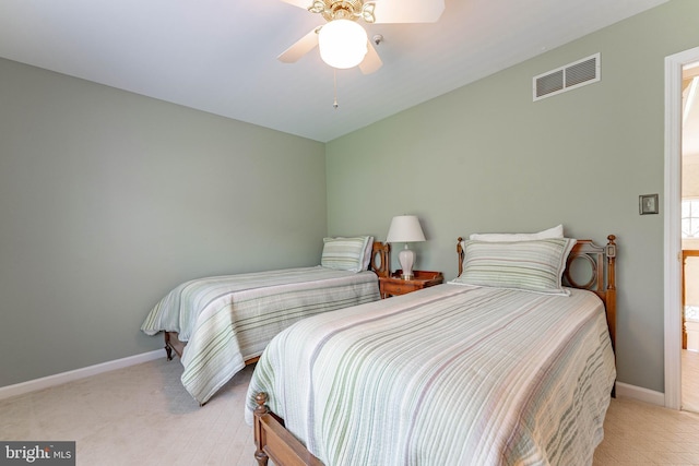 bedroom with baseboards, ceiling fan, light colored carpet, and visible vents