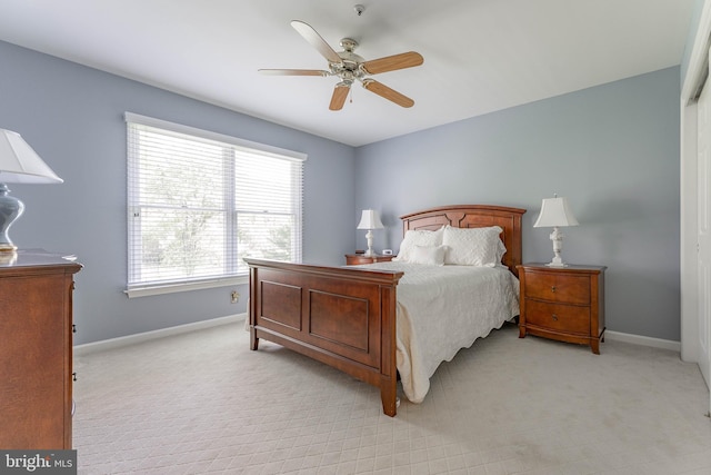 bedroom with baseboards, light carpet, and ceiling fan