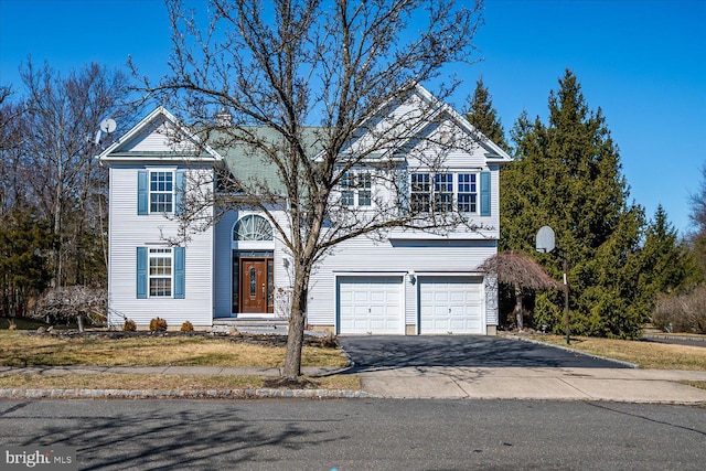 traditional-style home with a garage and driveway