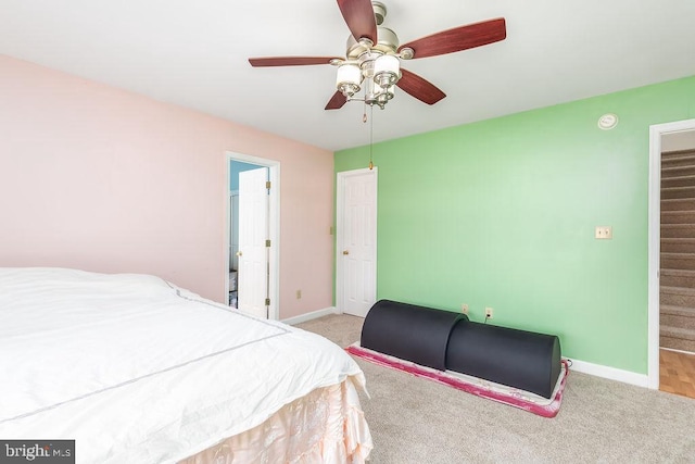 bedroom featuring light carpet, ceiling fan, and baseboards