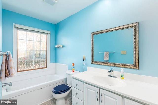 bathroom with visible vents, vanity, toilet, and a bath