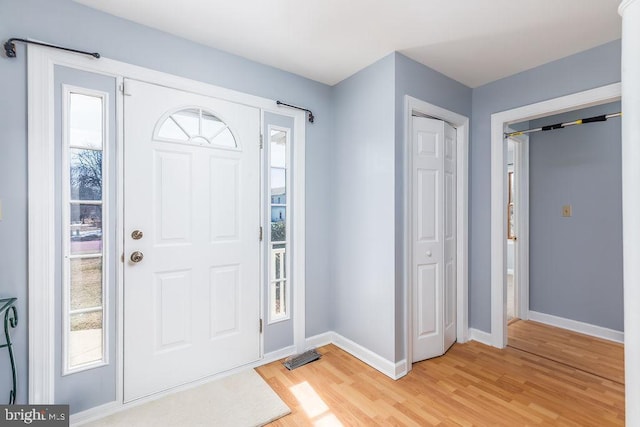 entrance foyer featuring light wood finished floors and baseboards