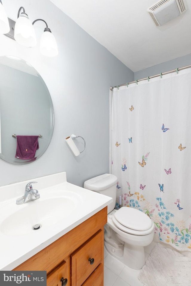 full bathroom with visible vents, vanity, toilet, and tile patterned floors