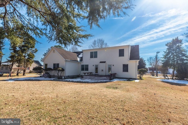 back of property with crawl space and a lawn