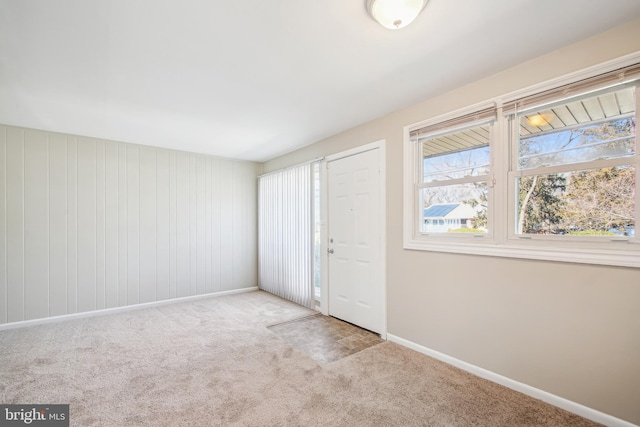 interior space with light carpet and baseboards