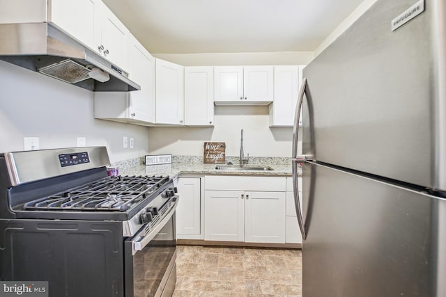 kitchen featuring appliances with stainless steel finishes, white cabinetry, a sink, and under cabinet range hood