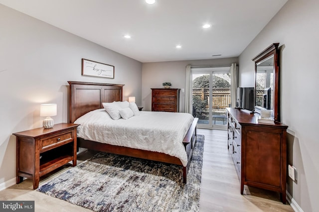 bedroom featuring access to exterior and light hardwood / wood-style floors