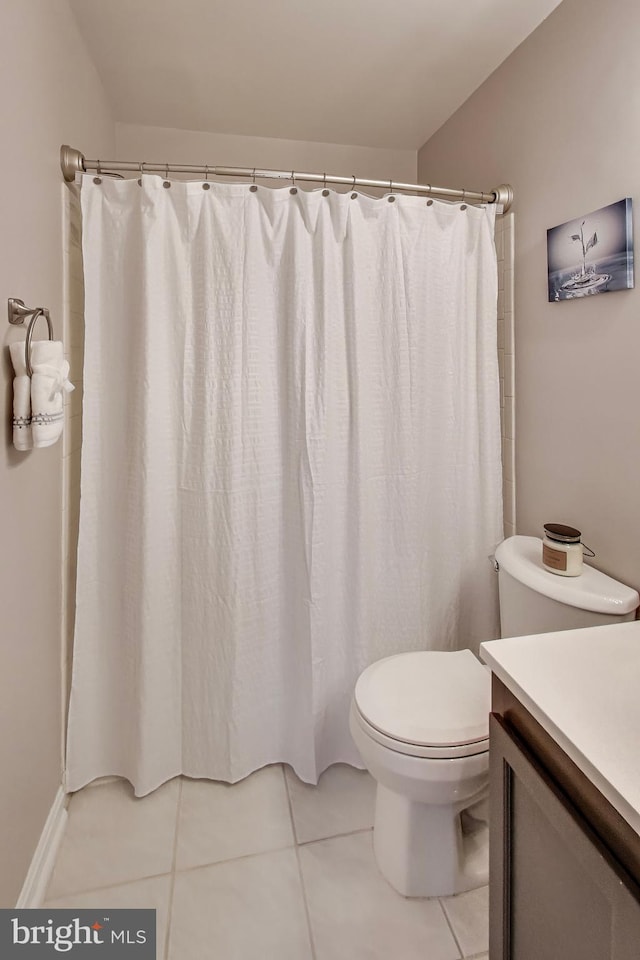 bathroom with tile patterned flooring, vanity, and toilet