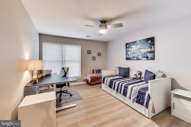 bedroom with ceiling fan and light wood-type flooring