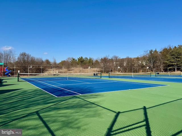 view of sport court featuring a playground