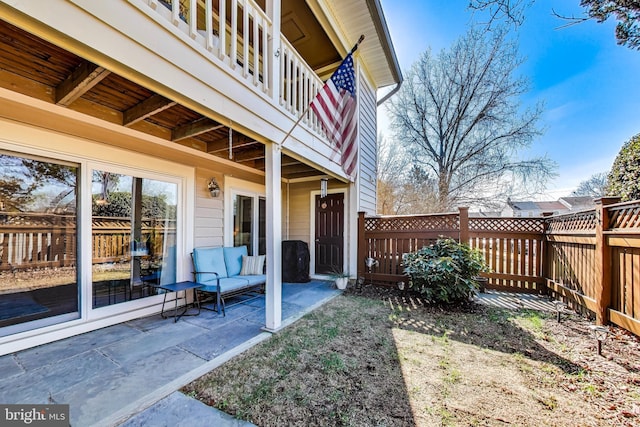 view of yard with a patio and a balcony